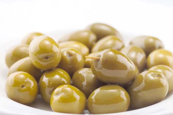 Green olives on white plate — Stock Photo, Image