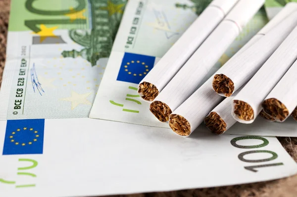 Dinheiro e cigarro — Fotografia de Stock