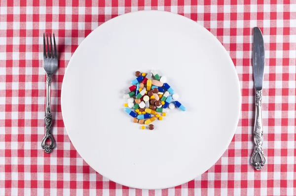 Pastillas en el plato —  Fotos de Stock