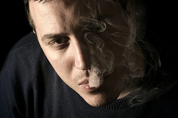 Man with smoke in mouth — Stock Photo, Image