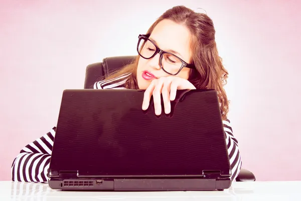 Sleepy woman on laptop Stock Photo