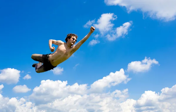 Crazy flying man in clouds — Stock Photo, Image