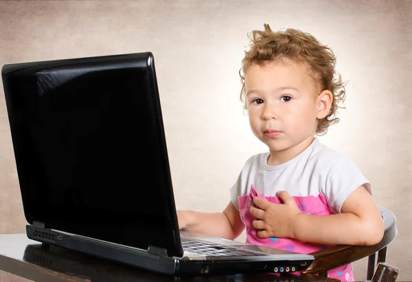 Little child sitting on laptop — Stock Photo, Image