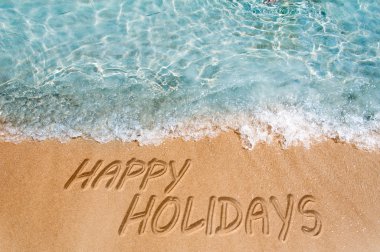 Holidays sign on sand