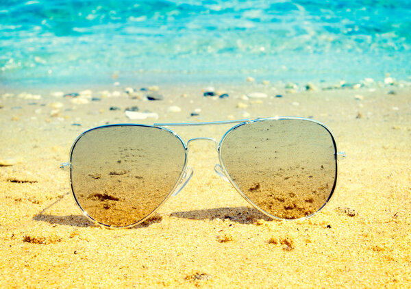 Aviator sunglasses on beach