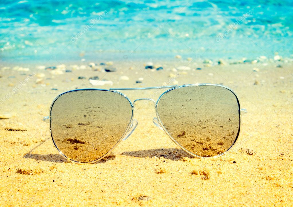 Aviator sunglasses on beach — Stock Photo © uroszunic #51244767
