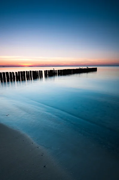 Vågbrytaren sunset — Stockfoto