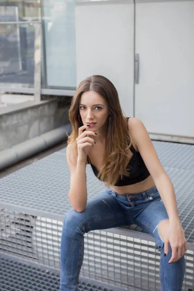 Attractive Young Female Jeans Top Looking Camera While Sitting Stairs — Stock Photo, Image