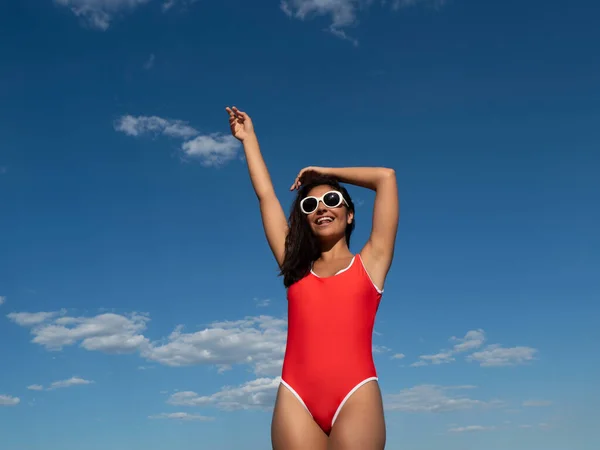 Low Angle Smiling Female Red Swimsuit Standing Raised Arm Blue — Stok fotoğraf