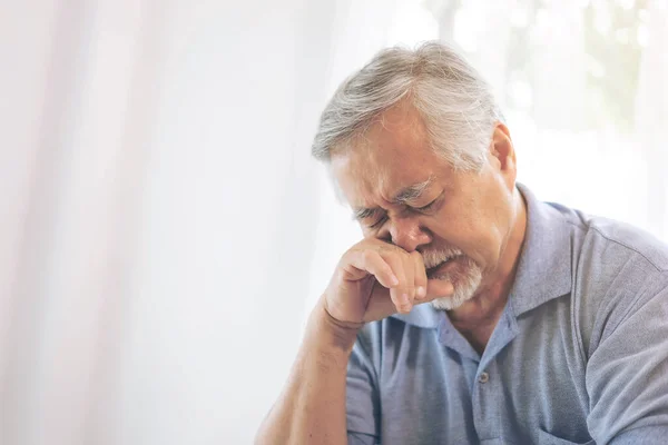 Asian senior man , retired old man Waking up with allergies , stuffy nose due to climate change , Elderly patients in bed at home - medical and healthcare concept