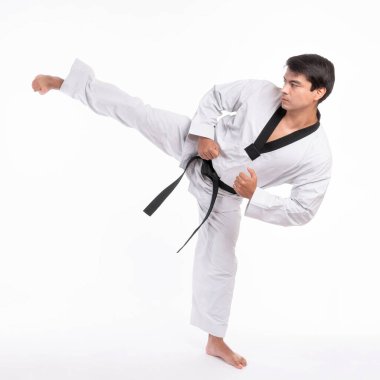Tekvando yüksek tekmesi - siyah kuşak tekvando sporcusu dövüş sanatları ustası, yakışıklı adam dövüş eğitiminde yüksek tekme pozu verdi.