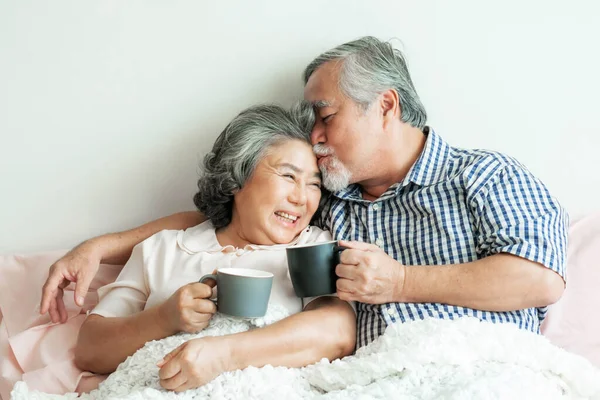 senior couple happy love Elderly couple smile face, old man and senior woman relaxing in bed room drinking coffee in the morning  - lifestyle senior love couple healthy concept