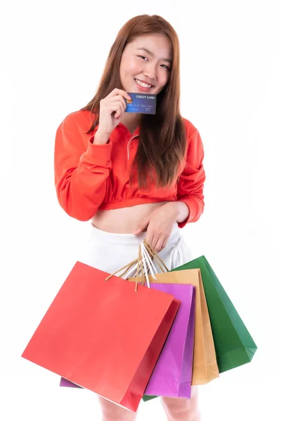 若いですかなりアジアの女性保持多くのショッピングバッグとショークレジットカードのための支払いショッピング上の白い背景 — ストック写真