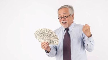 Business senior rich man Asian senior man , old man ,holding money US dollar bills in hand on white background , senior success business concept  