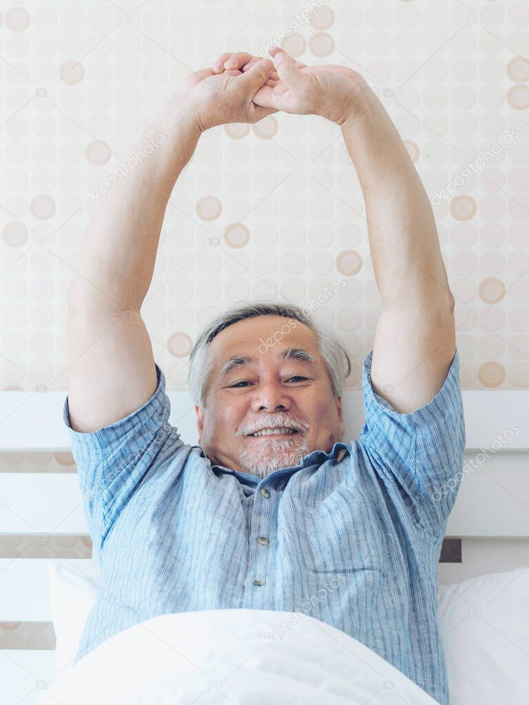 Senior man feel happy good health wake up in the morning enjoying time in his home indoor bedroom background - lifestyle senior happiness concept
