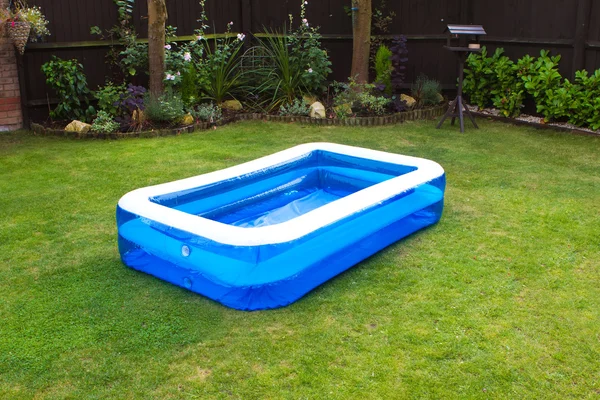 An inflatable swimming pool in an english garden Stock Photo