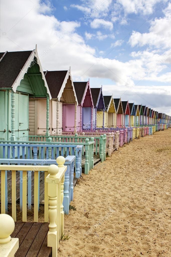 Row of colourful beach huts in rural essex