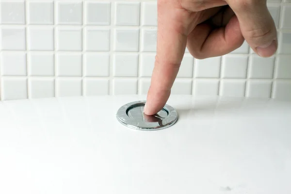 Flushing the toilet mand finger — Stock Photo, Image