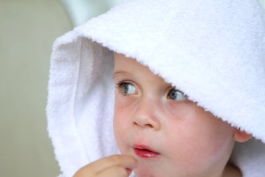 küçük çocuk beyaz banyo bornoz giyiyor
