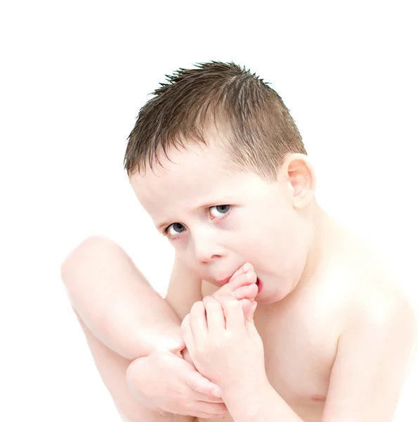 Little boy eating biting his toes — Stock Photo, Image