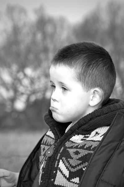 Sad little boy in the countryside — Stock Photo, Image