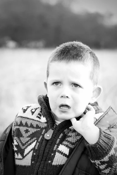 Sad little boy in the countryside — Stock Photo, Image