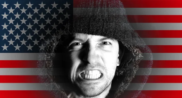 Hooded angry man with American flag design on face — Stock Photo, Image