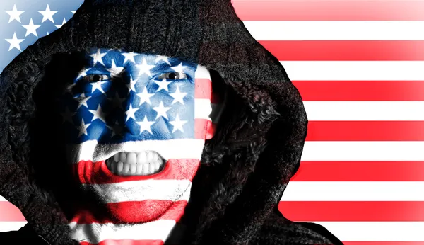 Hooded angry man with American flag design on face — Stock Photo, Image