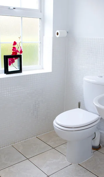 White toilet in a clean white tiled bathroom — Stock Photo, Image