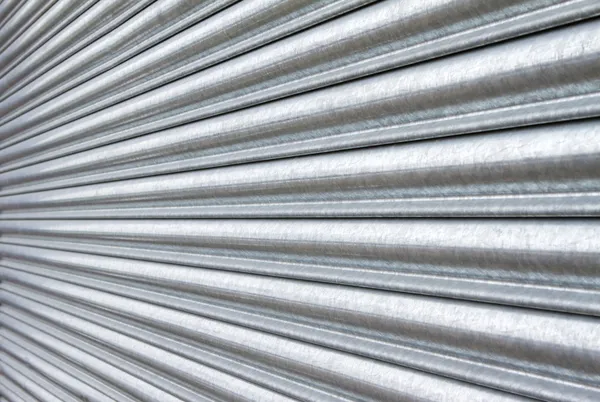 Silver metal roller security shutters closed down — Stock Photo, Image