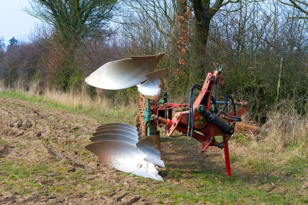 Agricultural plough machine in a field in the spring — Stock Photo, Image