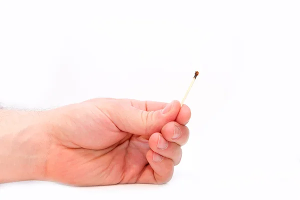 A burny out match in a mans hand Stock Photo