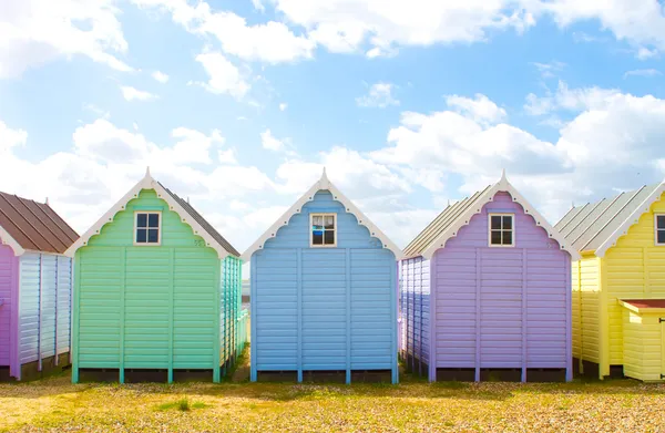 Traditional British beach huts on a bright sunny day Stock Image