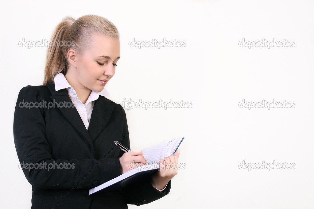 Young business woman making entries in a diary
