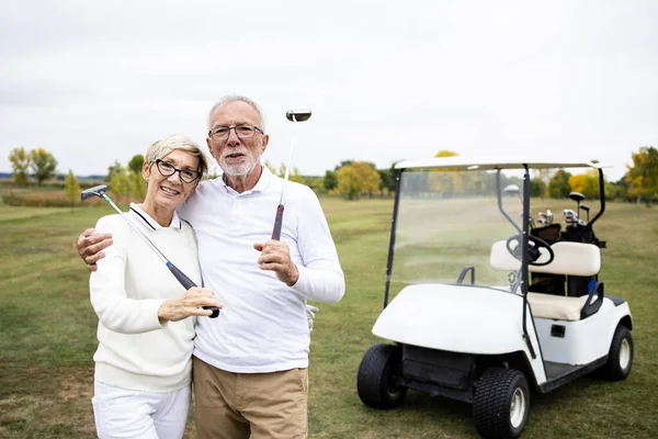 Golf sahasında golf sopaları olan Kafkas golfçülerin portresi..