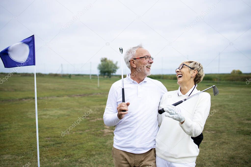 Portrait of senior people or golfers enjoying retirement by playing golf.