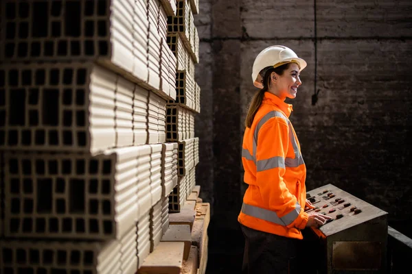 Factory worker working in clay bricks factory making products for construction industry.