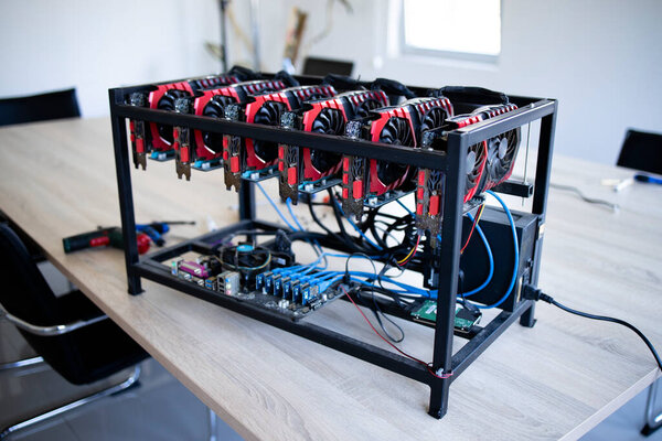 Cryptocurrency mining rig with graphics cards in row mining bitcoins.