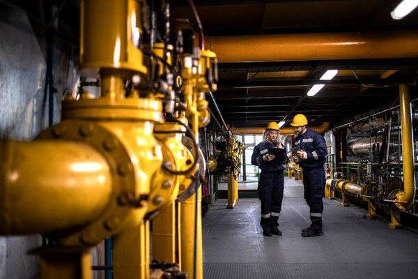 Oil and gas petrochemical production. Industrial or factory engineers discussing about gas storage and distribution.