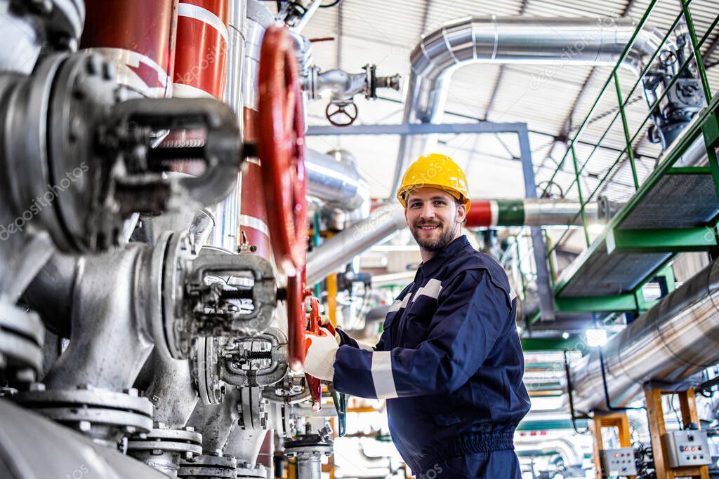 Portrait of an industrial worker in protective work wear in refinery or oil factory.