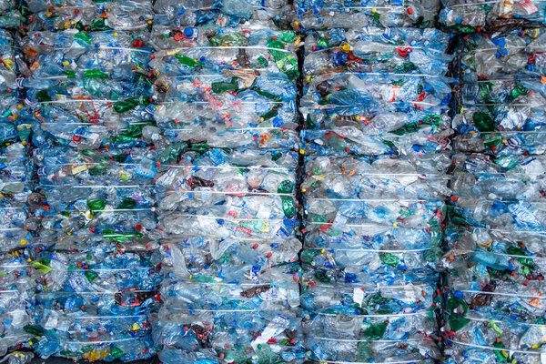 Large pile of plastic PET bottles compressed and ready for recycling.