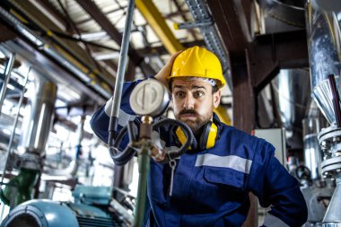 Portrait of factory worker in panic having problem with production trying to find solution for the problem.