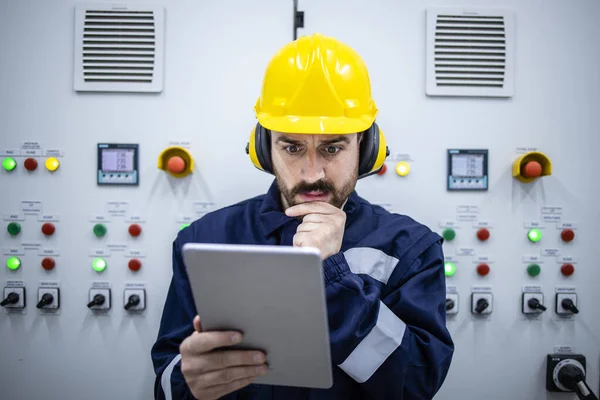 Portrait Thoughtful Industrial Electrical Engineer Looking Electric Scheme Trying Fix — Fotografia de Stock