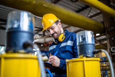 Working in natural gas refinery plant.