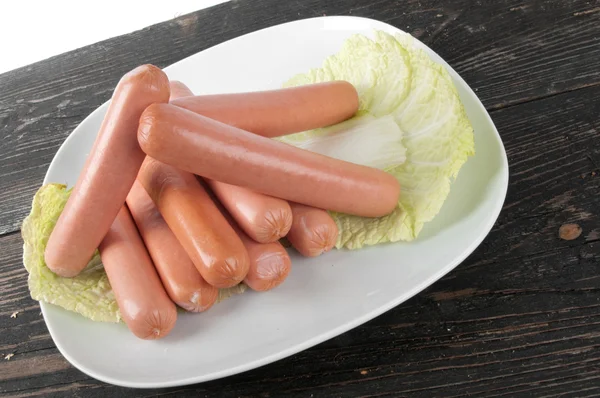 Fresh sausages on a plate — Stock Photo, Image