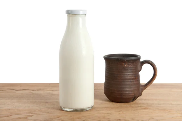 A bottle of milk and mug — Stock Photo, Image