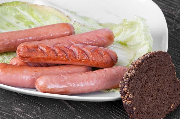 Grilled sausages on a plate — Stock Photo, Image