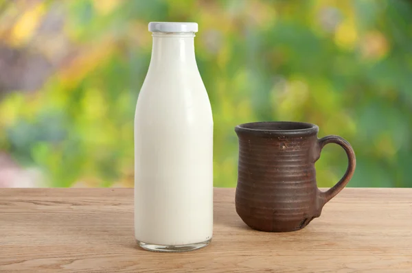 A bottle of milk and mug — Stock Photo, Image