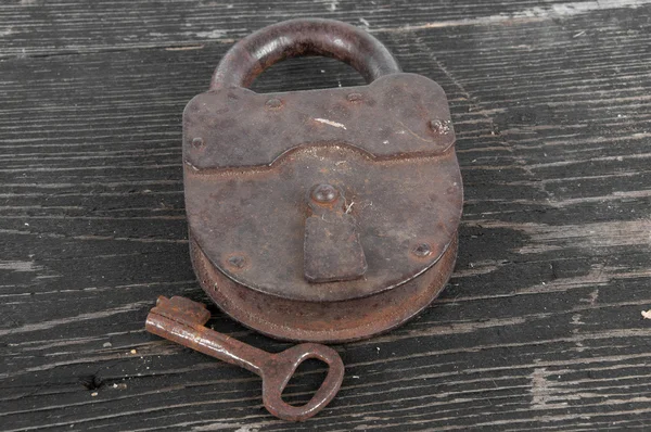 Old lock with a key — Stock Photo, Image