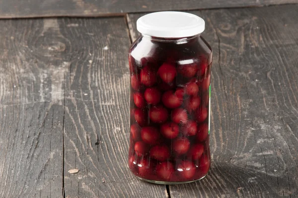 Cherry compote in a glass jar — Stock Photo, Image